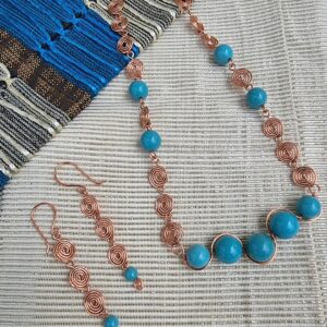 Handcrafted copper necklace and earrings with reconstituted  turquoise beads.  Anne Lawal Jewellry